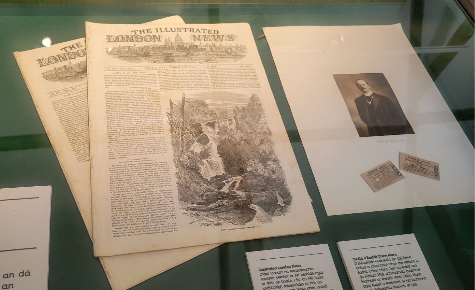 Historical documents, including a news article and a photo on display at Killarney House.